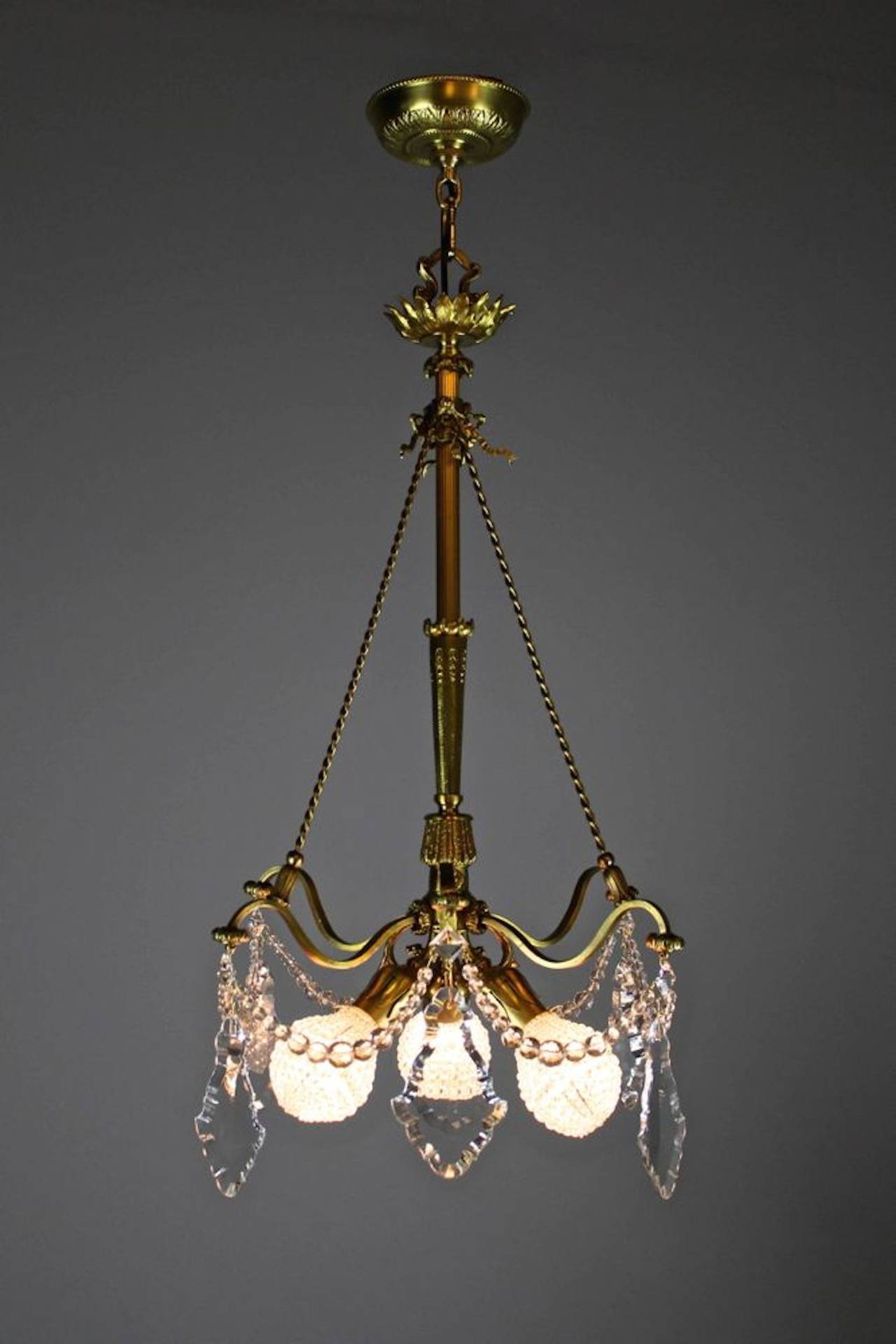 A super rare, elegant and dainty crystal basket chandelier attributed to Caldwell, circa 1905. This is an American made light done in a light-hearted decorative French style. Featuring delicate cut crystal  and cut crystal beading.
Measurements: