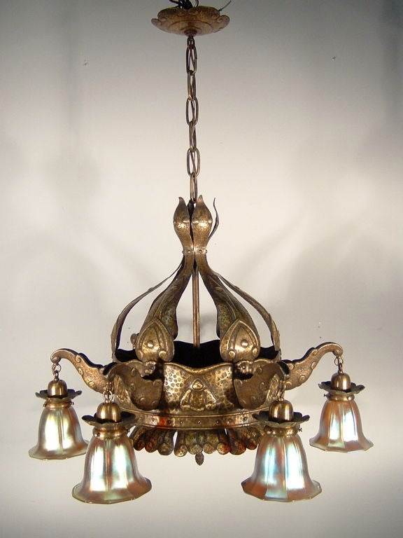 Impressive Arts & Crafts hammered brass fixture with six arms, fitted with re-cast art glass shades, circa 1915. Original condition, re-wired.
Measurements: 41