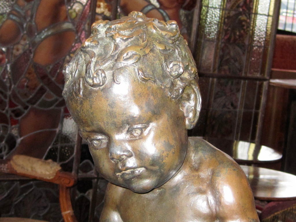 Bronze sculpture depicting an infant at a birdbath by award winning artist Brenda Putnam (1890-1975), signed and dated 1914. Born in Minneapolis on June 3rd, 1890, Miss Putnam began to exhibit in 1910. This piece is from a series of children as