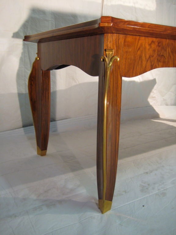 A signed coffee table by Leleu in walnut with eglomise mirror top and gilded bronze mounts.<br />
(signed Leleu in Ivory on bottom)
