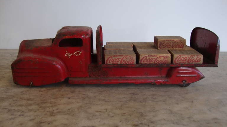 Great toy truck, with wooden Crates and Coke logo on side..   Missing front grill