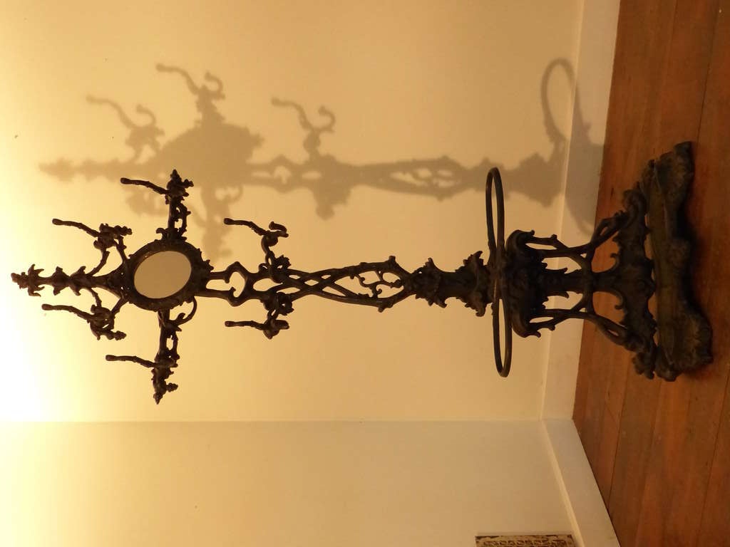 Victorian cast iron coat rack with original black finish , great casting , drip pan ,  and perfect unbroken condition.  Made in USA