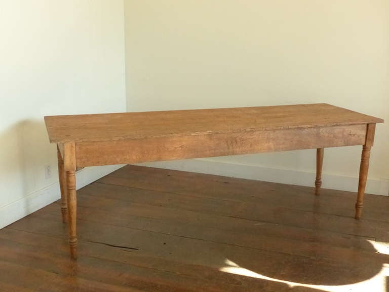 Pine harvest table with single drawer on end. Stripped with turned legs, found in Quebec