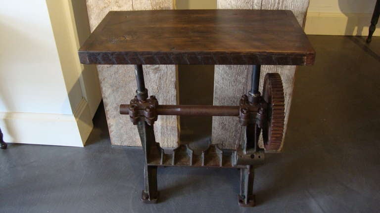 Table, with thick wood top on old early 20th century cast iron gear 