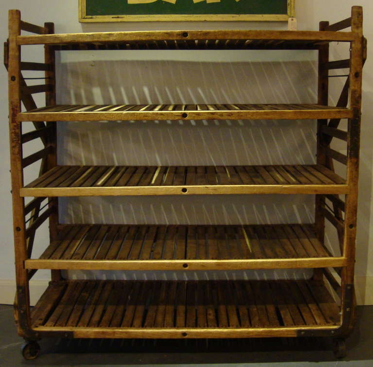 Wood/slated bread racks in original condition, on roller casters