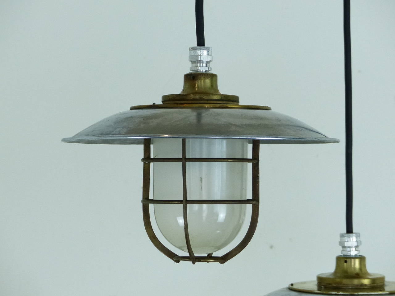 Set of four nautical pendants in brass and steel with clip on brass cage and glass bulb protecter