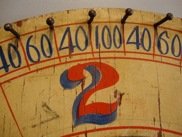 Painted game wheel in original paint. Strong colors on both side with pin nails surrounding outer edge.