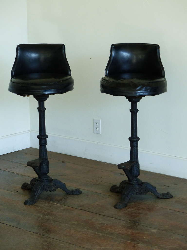 Heavy cast iron base with leatherette back and seat.