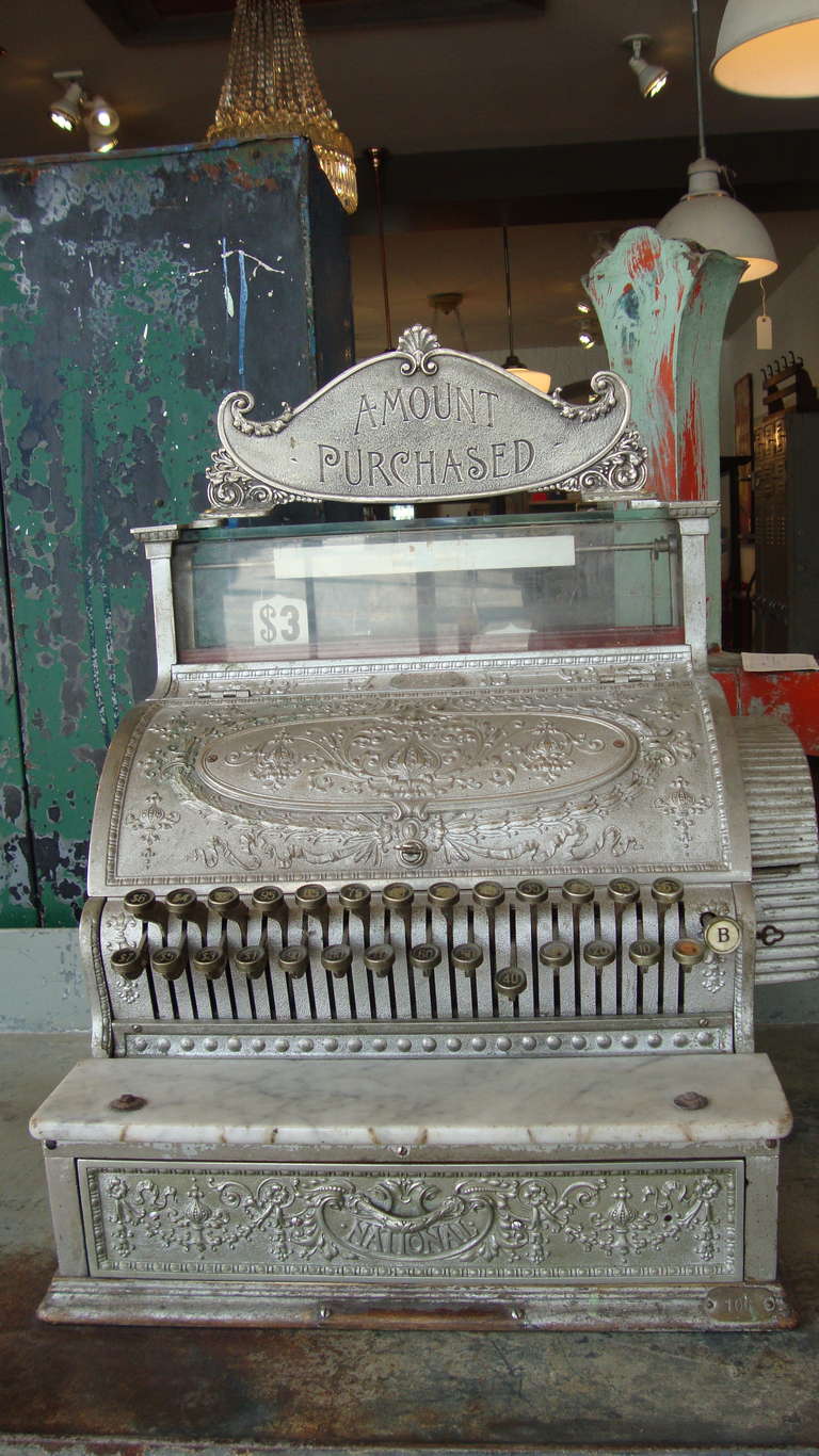 Cash Register in working order with superb casting on face and sides. Marble front plate and top purchased header.