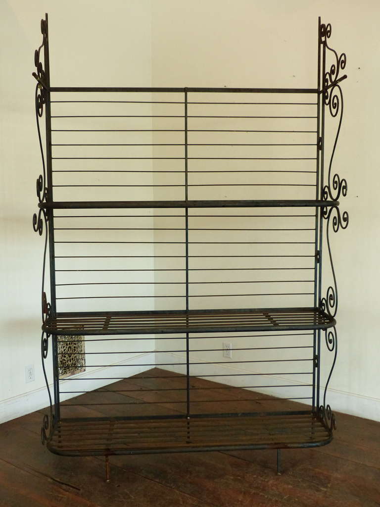 Bent iron bread rack. Steel shelves with decorative sides