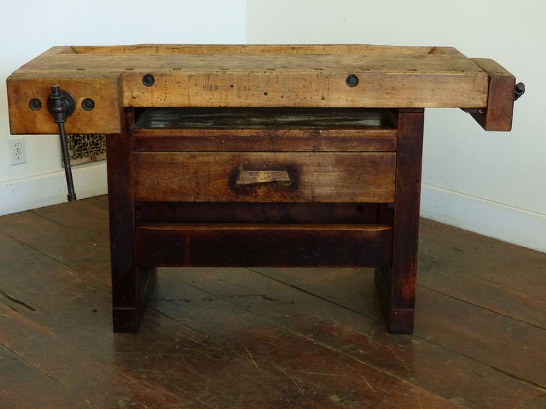 Heavy maple workbench with on drawer and two vices. top detaches from the base. Great smaller size for a desk