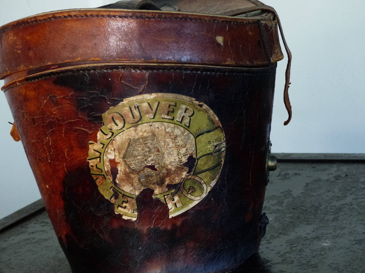 Antique leather hat box with excellent patina and large Vancouver, Canada shipping stamp. Untouched condition, with red satin lining.