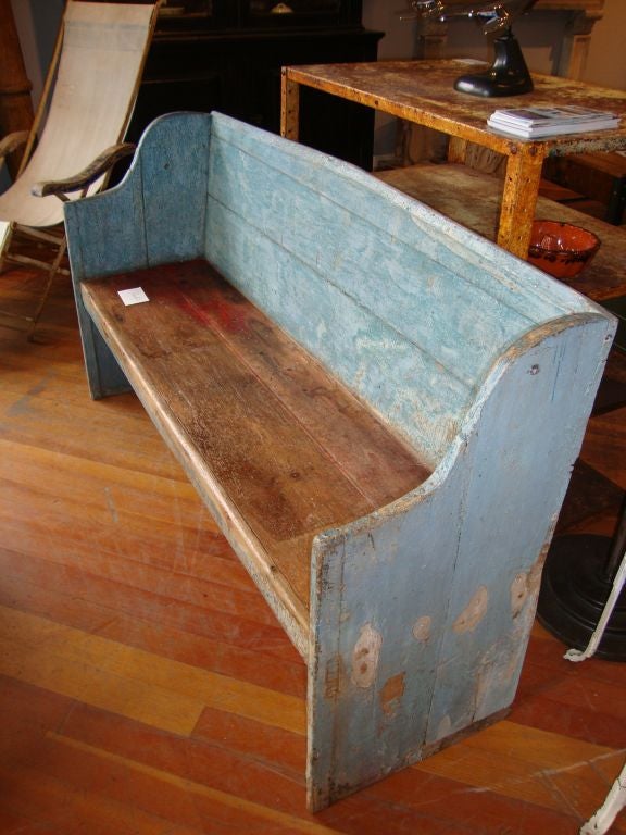 Rare pine bench with scrolled sides and nice shaped back..Piece retains it's old polychromatic surface blue with untouched sides  and scrubbed seat. Found in Newfoundland.