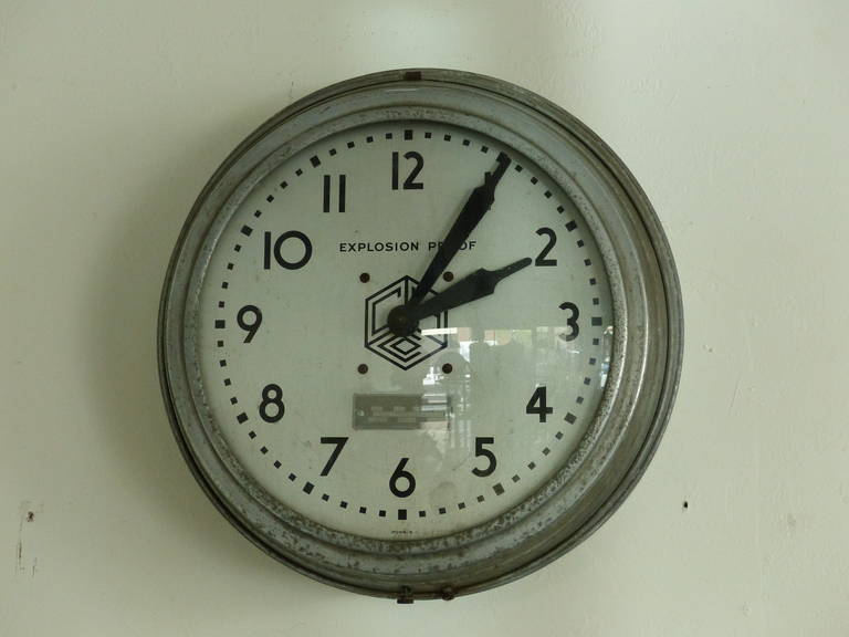 Nice simple clock in working order  with galvanized surround .