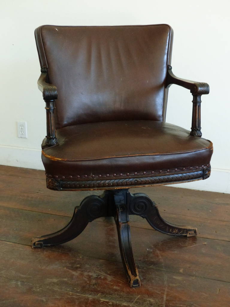 Rare Canadian bankers chair from a major bank in Canada. Aged leather over wood frame and swivel base