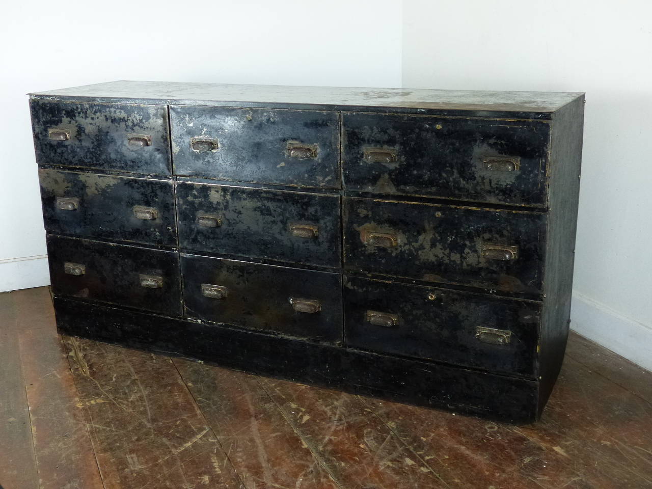 Excellent metal cabinet retaining traces of original black finish with stencilling hilights. The original handles are a detailed brass and are original to the piece.
Drawers are functional .