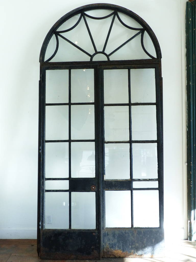 Incredible set of doors salvaged from a conservatory in a prominent affluent historic housing community in Montreal QC. These doors are in their frame with detailed dome top transoms. We have a set of five. Some restoration required, but with very