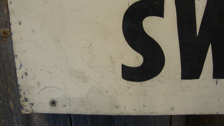 Store sign in original paint on tin.
