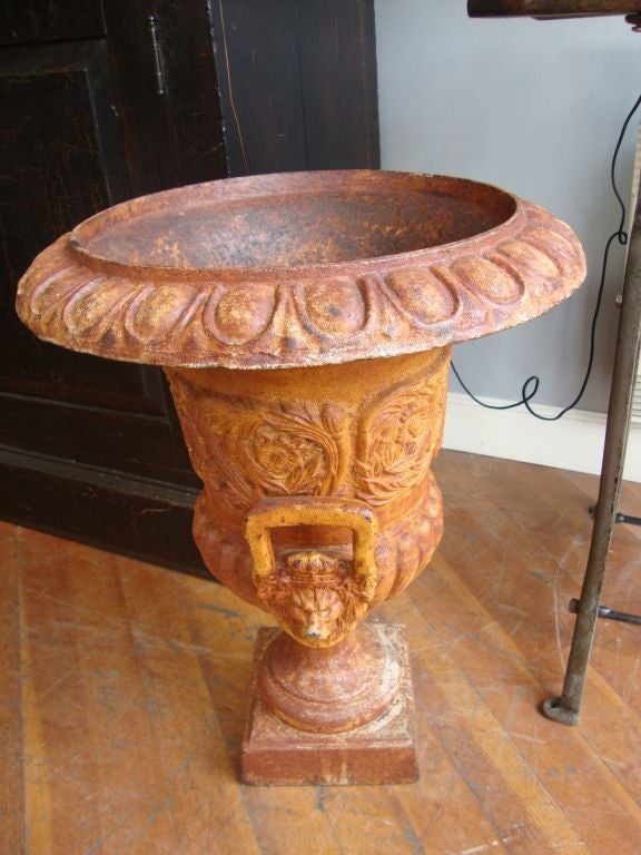 Pair of outstanding cast iron urns in old painted patina with lion face handles believed to have been forged in Albany, NY   Found in Colburg, Ontario