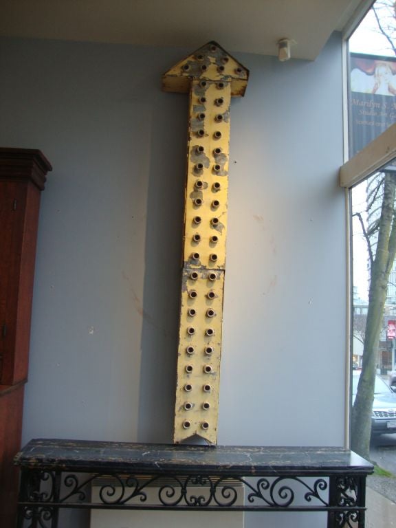 Large tin arrow sign with original ceramic bulb holders in a great old worn yellow finish