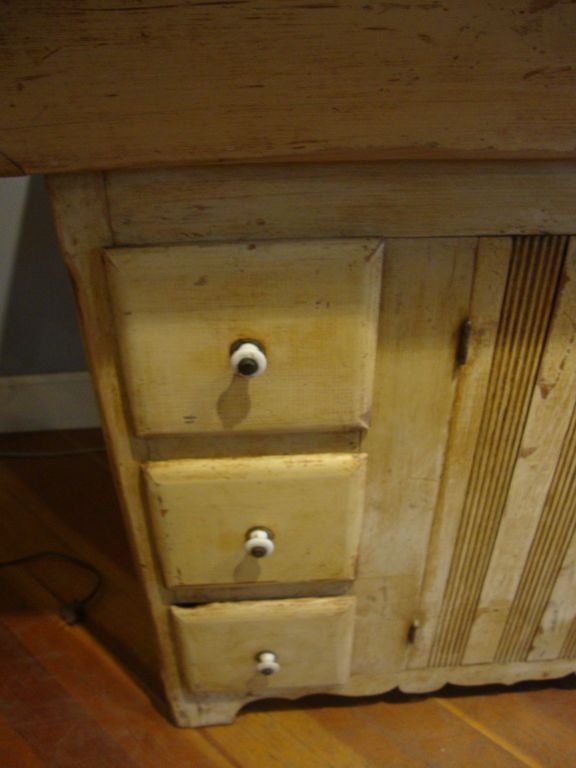 Pine Dry sink with original surface paint. Tin covering with shelf and three side drawers and bracket base