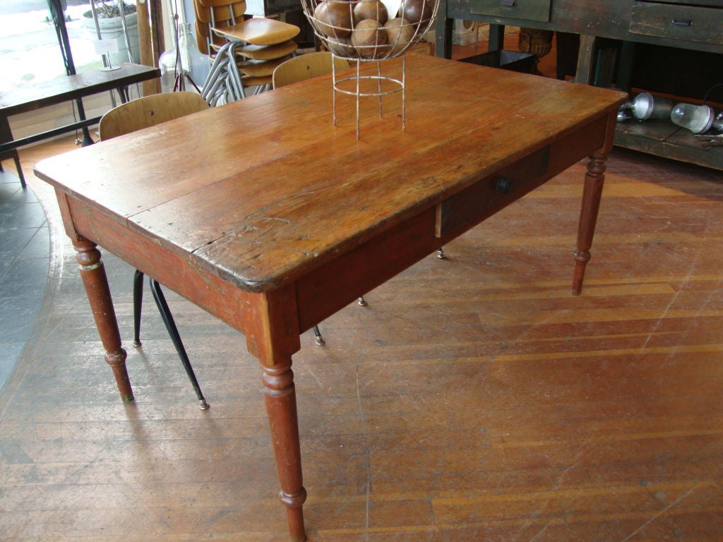 Quebec two board top table, retaining original red paint on base. This example has a drawer on the side with typical 19th century form turned leg.
