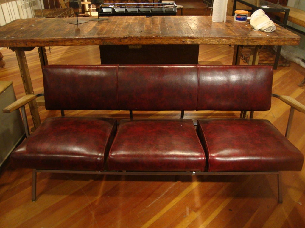 Vintage couch, in original covering, chrome splayed legs with wooden arm rests. No rips or fading