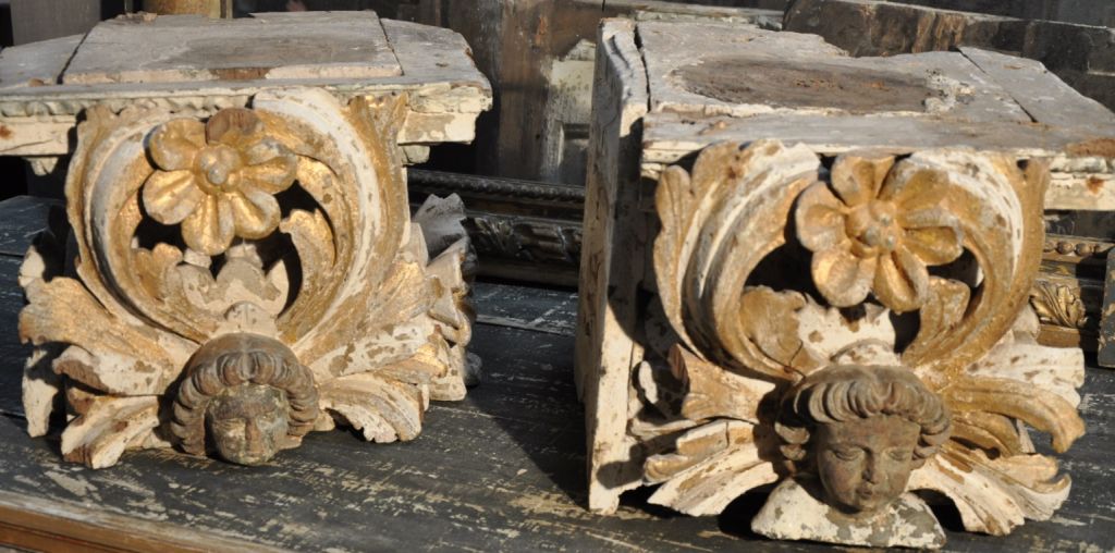 Pair of carved gilt wood Italian capital with putti