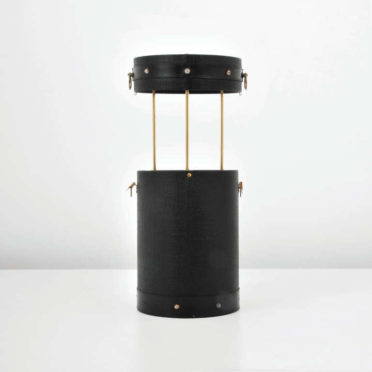 DESIGNER & MANUFACTURER: Jacques Adnet

MARKINGS:  none

COUNTRY OF ORIGIN & MATERIALS:  France; leather, brass, glass, wood

ADDITIONAL INFORMATION & CIRCA: Pop-up bar by Jacques Adnet. (Key Word Search: Maison Bagues / Charles, Jean Royere,