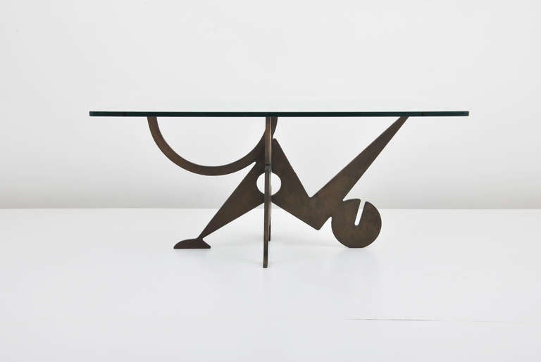 DESIGNER & MANUFACTURER: Pucci de Rossi (1947-2013)

MARKINGS: marked, dated 1987

ORIGIN & MATERIALS: Italy; metal, glass

ADDITIONAL INFORMATION: Wonderfully designed coffee/cocktail table crafted with two pieces of interlocking patinated