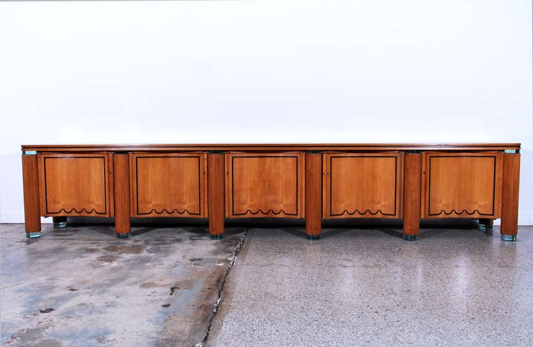 Monumental and important cabinet attributed to Giuseppe Terragni (Italian, 1904-1943) from the Novecento Italiano period. Six glass feet are spaced equally along the front of the cabinet with two glass feet in the rear. Each  column is wrapped with