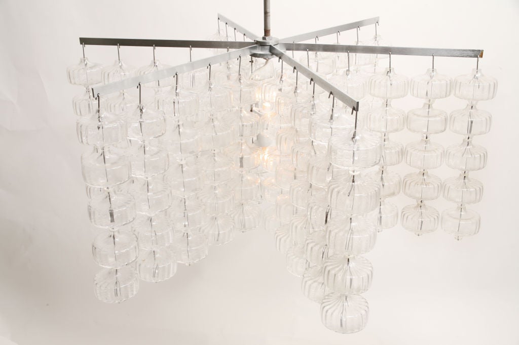 Unique and rare, absolutely stunning chandelier designed by Aloys Gangkofner. Six (6) minimalist matte steel arms with twenty-five (25) glass drops hanging from each arm, for a total of one hundred and fifty (150) individual pieces of hand blown