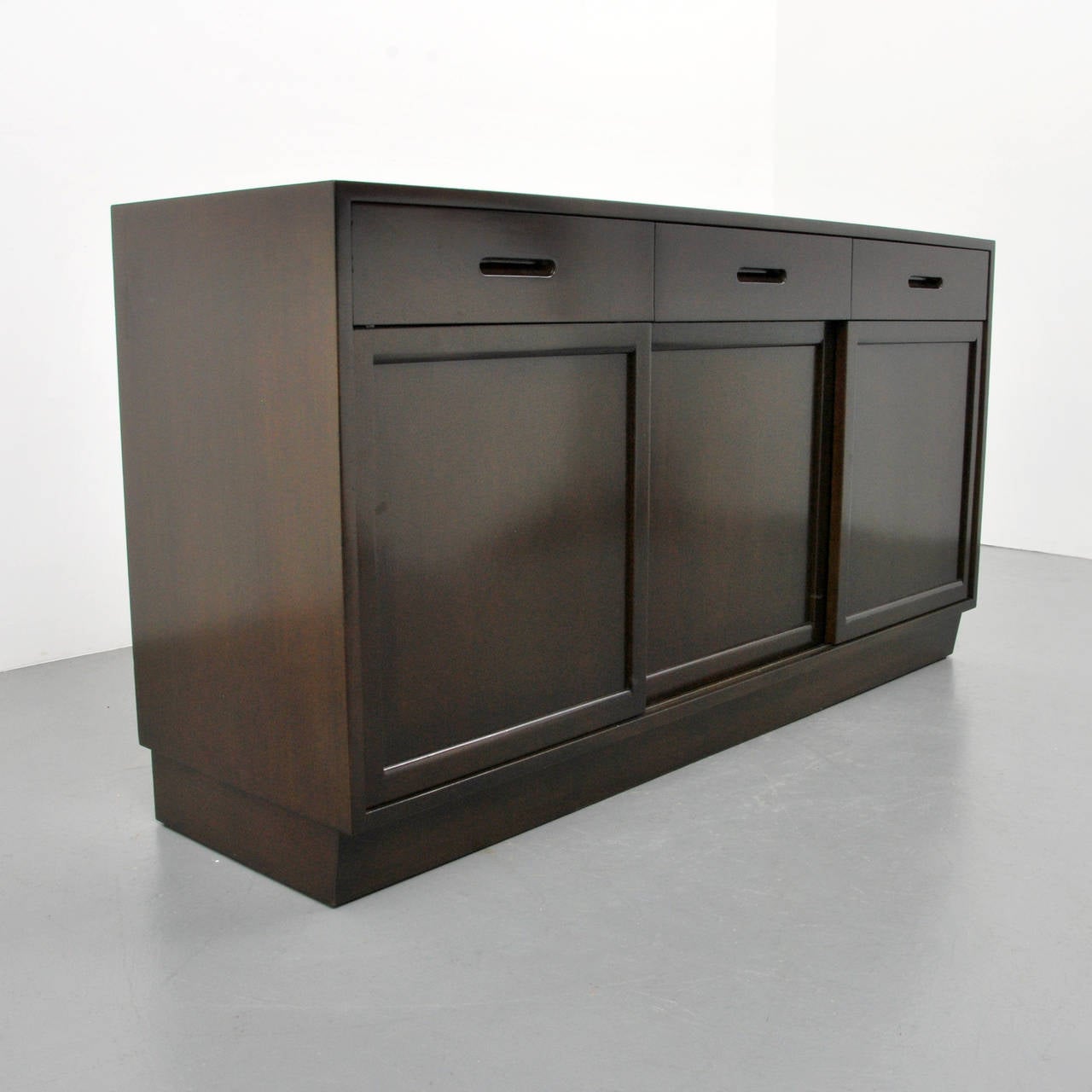Cabinet, dresser or server is a variation of model 5668 and features three drawers with separators, two end doors each revealing three pull-out shelves and storage, and center door revealing two adjustable shelves. Reference (similar form): Dunbar