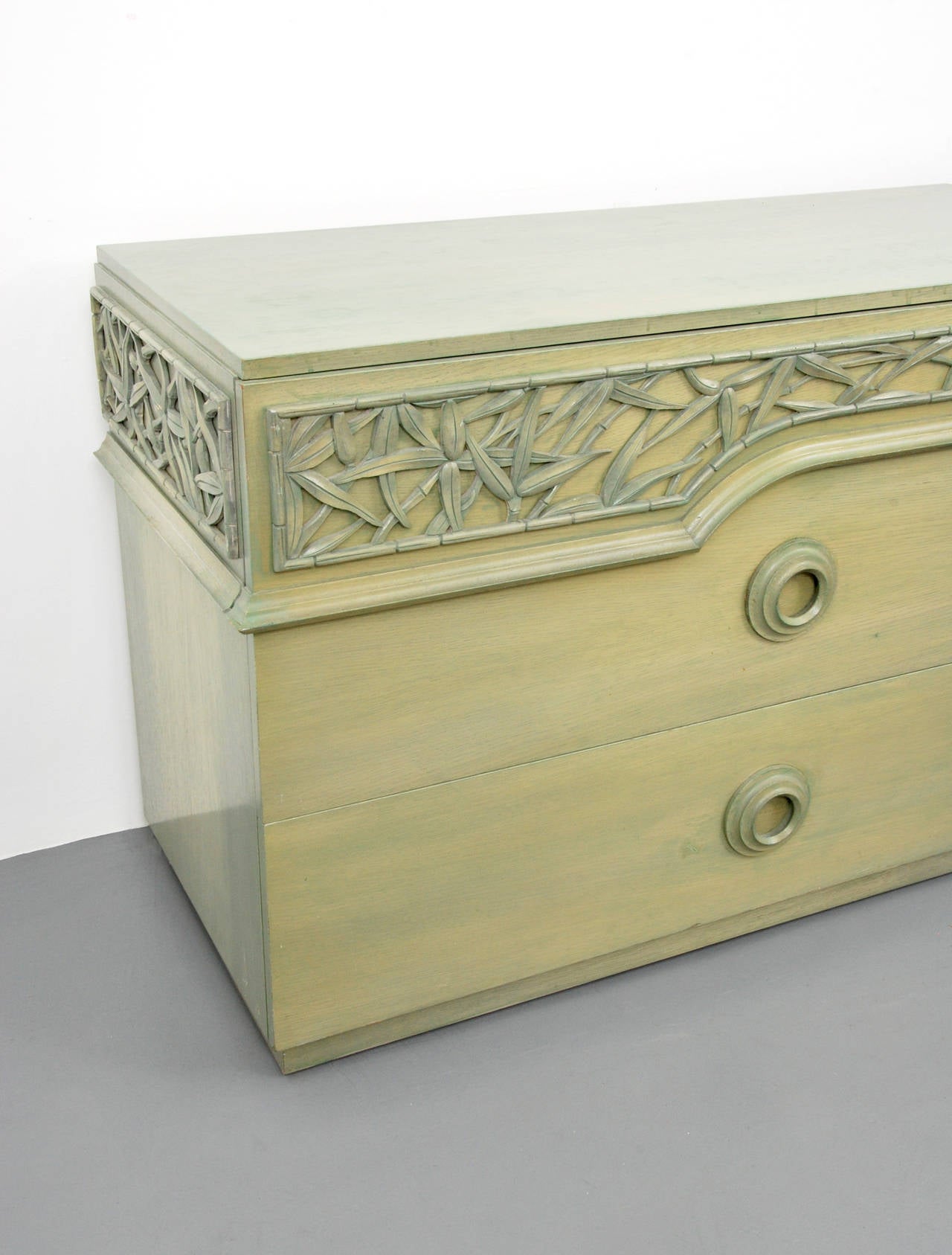 Cabinets join together to form one long cabinet. Each cabinet features three drawers with an applied tropical decoration. Sold as a set. Dimensions: 31.5