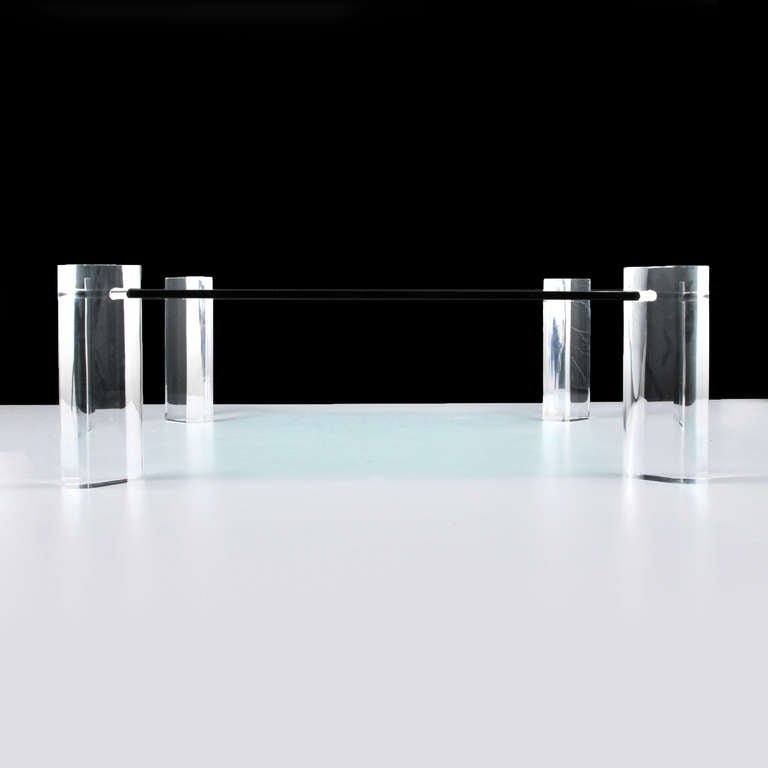 Large cocktail table with thick lucite supports by Karl Springer.
Streamlined and elegant minimalist design with a thick glass top held in place by four (4) large and heavy oval shaped lucite legs.

*Notes: There is no sales tax on this item if