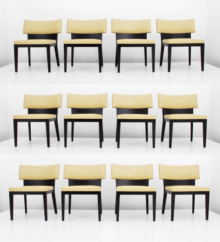 Set of six (6) dining chairs (12 shown) with leather seats and backs by Christian Liaigre for Holly Hunt. Beautiful dark stained solid mahogany frames with an upholstered, high quality leather seat and back in a soft celadon yellow shade. Elegantly