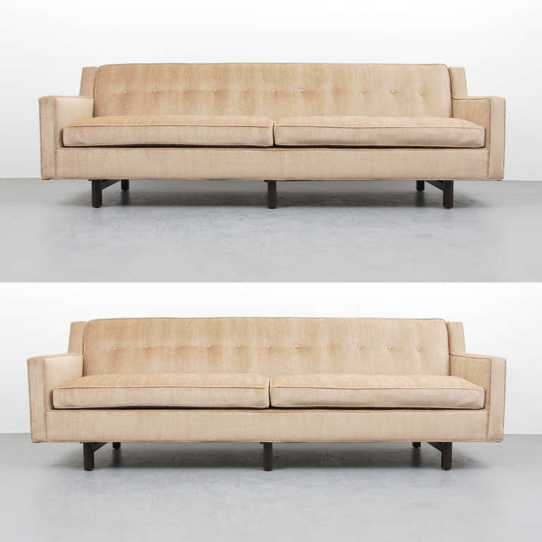 MARKINGS: marked

Sofa/couch by Edward Wormley. It has been reupholstered in matching fabric. One available.

Edward Wormley's furniture designs utilized quality materials and were understated and well-made, taking the elements from