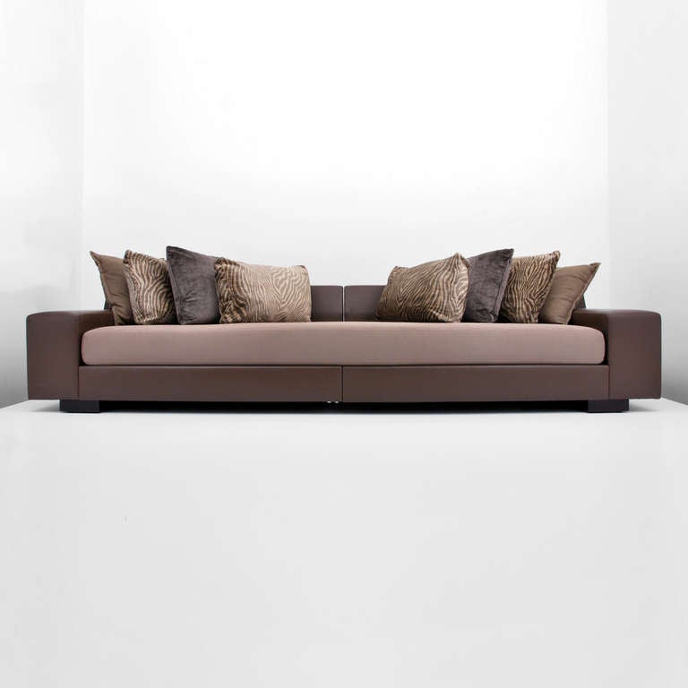 Large leather sofa by Christian Liaigre for Holly Hunt. Beautifully crafted, extremely comfortable ten foot (10') long sofa with fine quality, chocolate brown leather upholstery supporting a large upholstered seat cushion and eight (8) large pillows