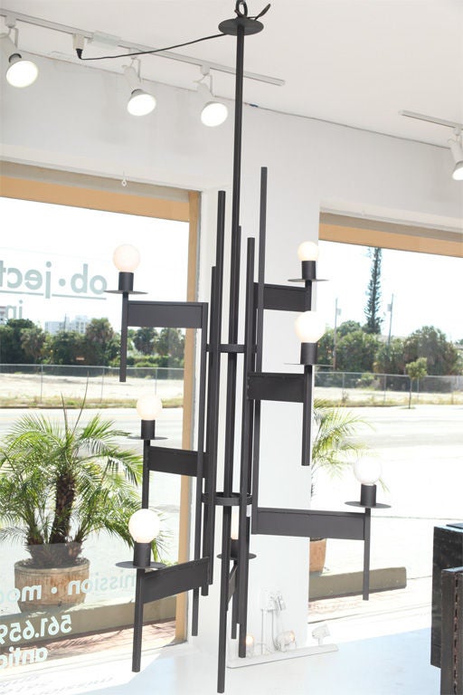 DESIGNER & MANUFACTURER: unknown

MARKINGS: none

COUNTRY OF ORIGIN & MATERIALS: USA; metal

ADDITIONAL INFORMATION: Massive seven (7) arm modernist chandelier. 

*Notes: There is no sales tax on this item if it is being shipped out of the