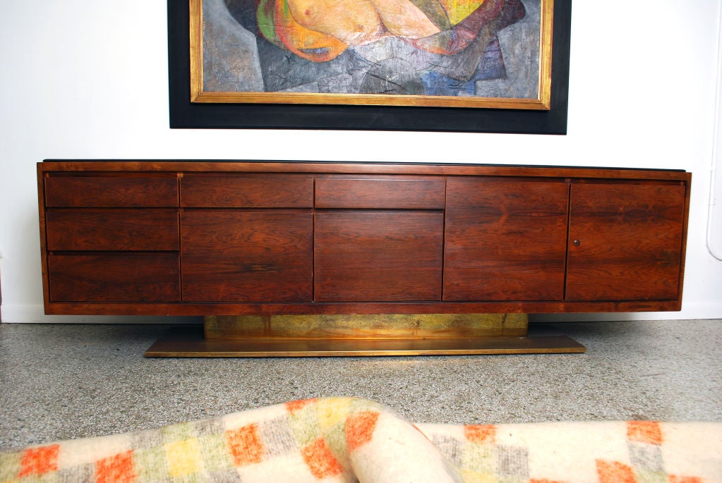 Cabinet; Fine & rare rosewood executive credenza designed by Warren Platner for Lehigh Leopold. Five drawers, two doors-one with a fixed shelf and the other adjustable, two file drawers and a leather top.<br />
<br />
*Notes: There is no sales tax