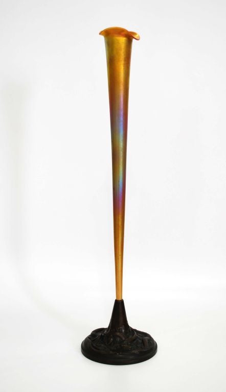 Fine iridescent floriform glass vase by Quezal on top a detailed bronze base.  Signed. *Notes: There is no sales tax on this item if it is being shipped out of the state of Florida (Objects20c/Objects In The Loft will need a copy of the shipping