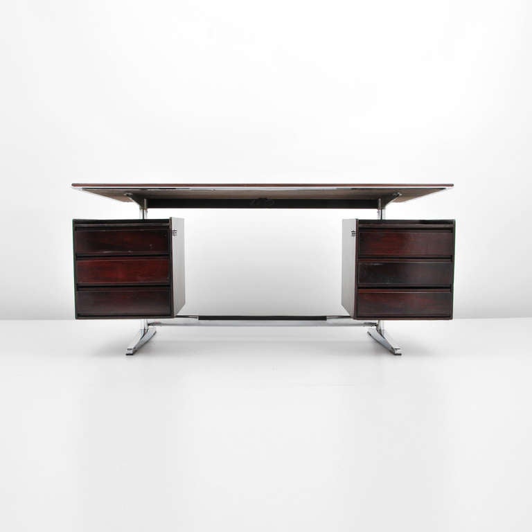 Designer & Manufacturer: Gio Ponti; Rima

Marking: marked

Country of origin & materials: Italy; rosewood, chromed steel, plastic

Additional Information & Circa: Rosewood desk with six drawers by Gio Ponti. (Key Word Search: Franco Albini,