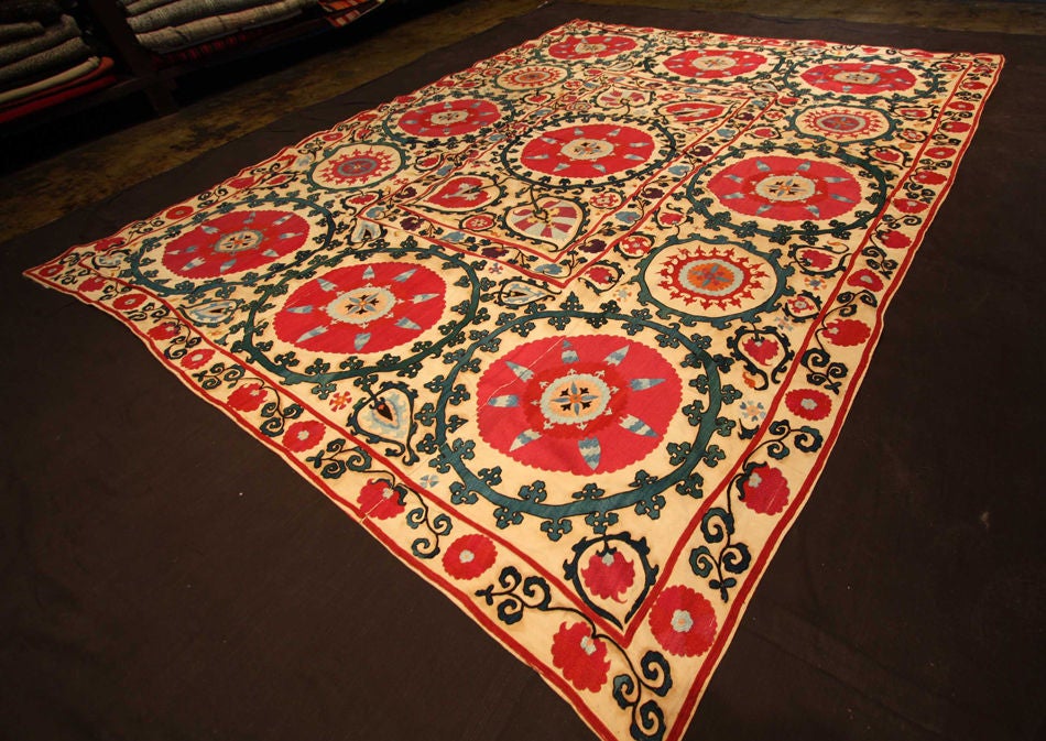 One of a kind antique Suzani made Uzbekstan. Very large piece with vibrant hues of pink, red, blue, teal and black. Condition is perfect.