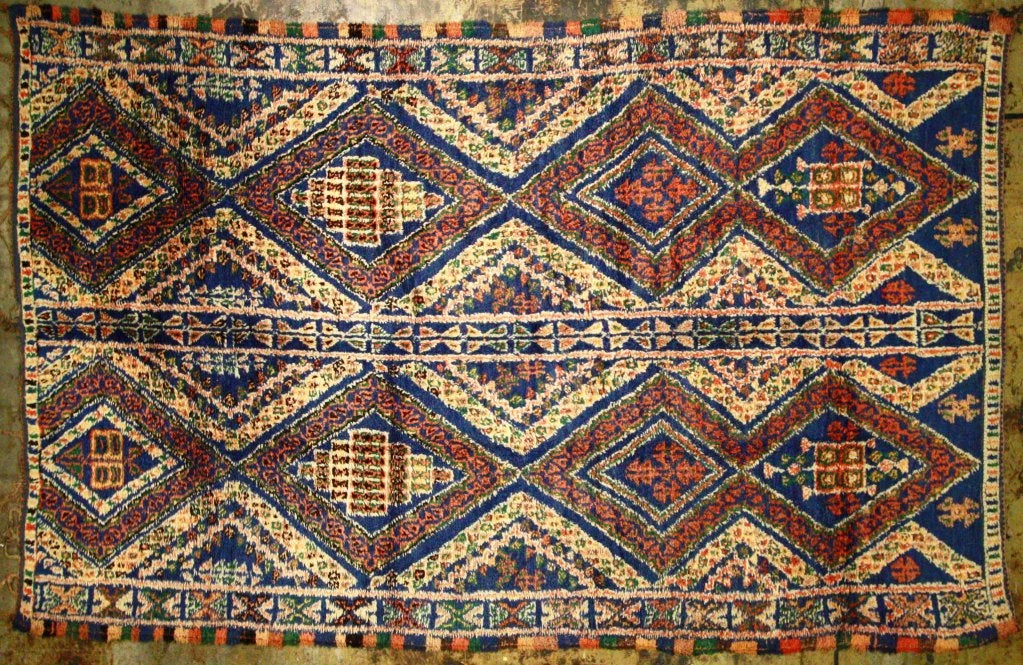 Vintage Moroccan Rug with geometric decoration in rich colorful tones.