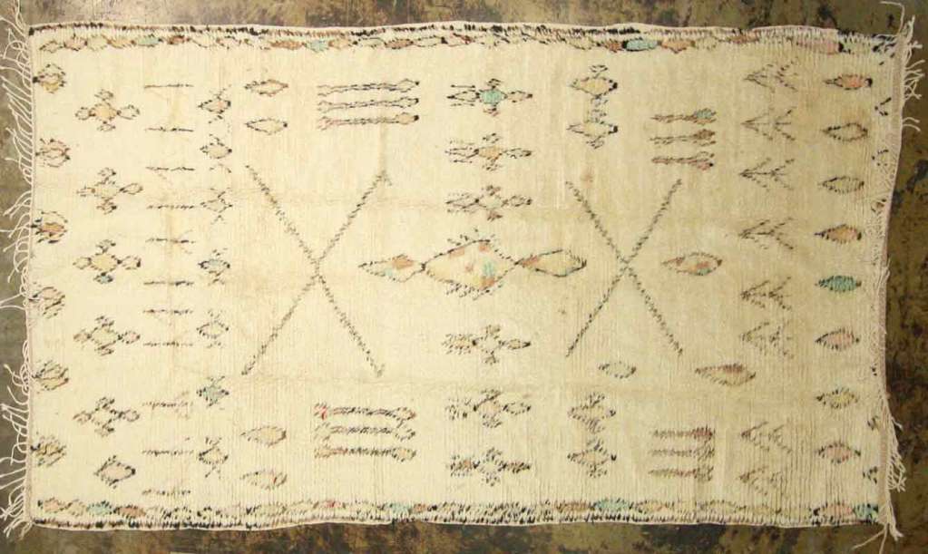 Vintage Moroccan rug with geometric decorations. The designs mostly tell the history of the tribe or the weavers history. Its also a way they express their daily preoccupations. Measures: 4'10 x 9'7.