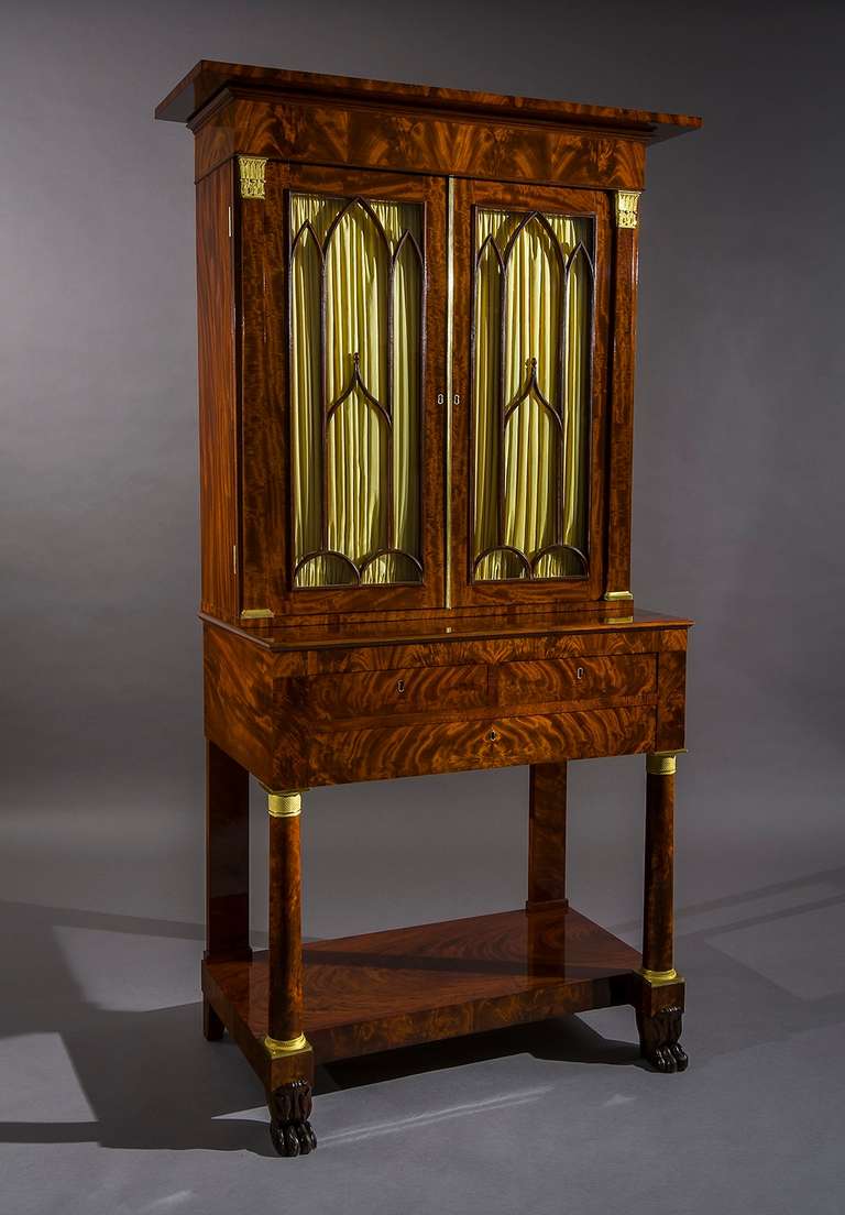 Attributed to Duncan Phyfe (1770-1854), New York, about 1820		
Mahogany (secondary woods: pine, poplar, and mahogany), with ormolu mounts, glass, brass hinges, steel locks, and leather writing surface, tooled, partially in gold.  79 ¾ in. high, 42