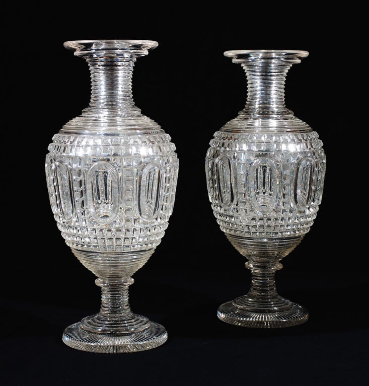 French, circa 1820.
Glass, blown and cut
17 5/8 in. high, 6 ¼ in. in diameter at base.

This extraordinary pair of vases of monumental scale represents the finest quality of French cut-glass of the Restauration period.

Although no firm
