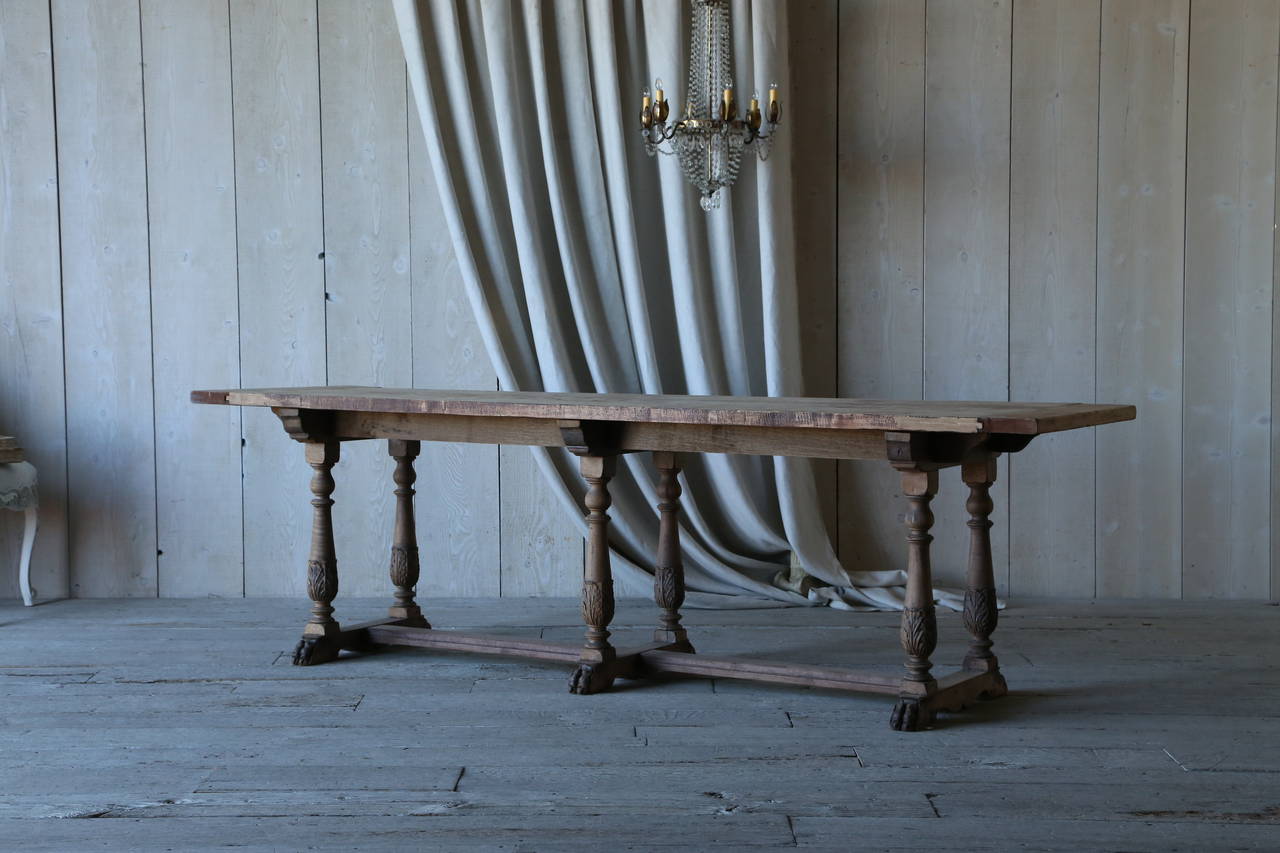 Gorgeous antique, unfinished mahogany Draper's table with amazingly carved claw feet. The six turned legs are adorned with an acanthus leaf motif at the base. The maple top of the table has picked up a very interesting pattern over the years. A