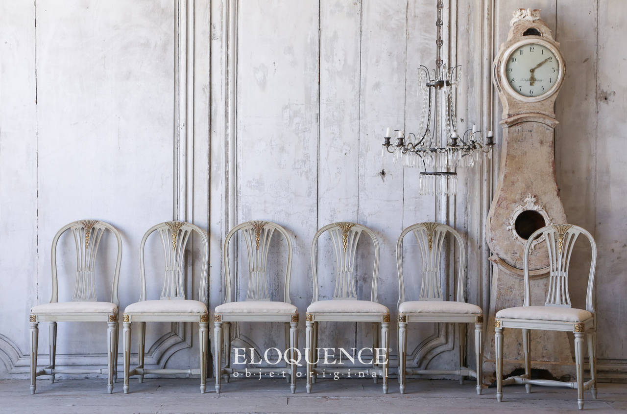 Incredible set of six Swedish Vintage Gustavian Style dining chairs finished in lightly distressed pale duck egg paint. These have been reupholstered in an oatmeal grain sack for extra old world charm. The balloon barred back is delicate and the