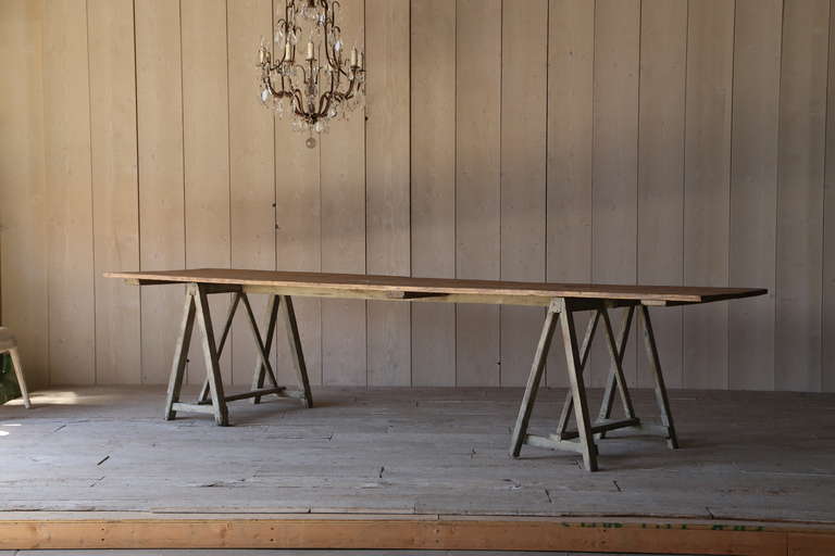 Rustic and beautiful Antique saw-horse table from Provence with faded original finish and bare wood top. Legs are a faded sage with such texture and rough luxe beauty. Such a large size makes this a perfect place to gather your closest friends for a